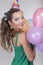 Brunette Woman in a Birthday Cap Holding Balloons and Smile