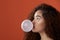 Brunette woman blow bubble gum ball