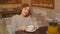 Brunette woman in a cafe drinking vitamin tea