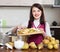 Brunette woman cooking pear jam