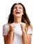 Brunette woman doing a winner gesture happy laughing excited looking up with closed eyes