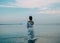 Brunette woman dress goes water sea color sky