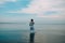 Brunette woman dress goes water sea color sky