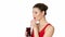 Brunette woman drinking cherry juice from glass