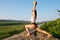 brunette woman fitness instructor training with ball outdoor. Green forest mountains and blue sky background