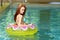 brunette woman in a floating water toy