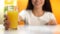 Brunette woman holding glass of orange juice, unsweetened beverage, vitamin c