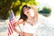 brunette woman holding USA flag outdoor