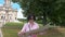 Brunette woman looks at paper map against the background of a historic building