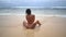 Brunette woman with naked back pose on wild beach