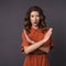 Brunette woman on a neutral background. Emotional portrait