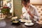 Brunette woman ordering meal in luxury Japanese restaurant.