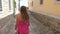 Brunette Woman In Pink Dress Walking The Street, Old Stone Town, View Back