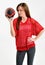 brunette woman in red mesh football jersey