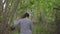 Brunette woman running through the forest looking back