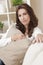 Brunette Woman Sitting Thinking At Home on Sofa