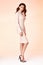 brunette woman skinny business style dress beige color perf