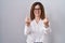 Brunette woman standing over white isolated background showing middle finger doing fuck you bad expression, provocation and rude