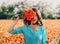 Brunette woman standing with poppies bouquet.