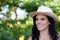 Brunette woman with straw hat walking