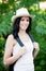 Brunette woman with straw hat walking