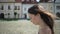 Brunette woman is walking alone in european town in summer day