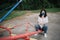 Brunette woman wearing antivirus mask resting in the park.