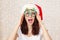 Brunette woman wearing funny carnival glasses for Christmas celebration.