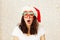 Brunette woman wearing funny carnival glasses for Christmas celebration.