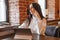 A brunette woman is working on a tablet at a table in a cafe. The theme of freelancing and free work schedule