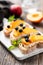 Bruschetta or appetizer toast with peach, ricotta, blueberries