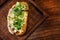 bruschetta with cheese and greens on a wooden cutting board for photos