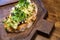 bruschetta with cheese and greens on a wooden cutting board for photos