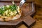 bruschetta with cheese and greens on a wooden cutting board for photos