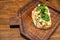 bruschetta with cheese and greens on a wooden cutting board for photos