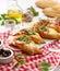 Bruschetta, grilled slices of baguette with mozzarella cheese, tomatoes, garlic and aromatic basil on a white wooden table