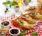 Bruschetta, grilled slices of baguette with mozzarella cheese, tomatoes, garlic and aromatic basil on a white wooden table