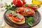 Bruschetta with liver pate, tomatoes and basil.