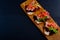 Bruschetta sandwiches with jamon, tomatos, lettuce leaves and green sprouts on wooden board.