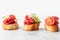 Bruschetta with sausage and vegetables on light gray background. Three of salami sandwiches as appetizer isolated with