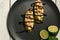 bruschetta with shrimps, avocado and lime on a white wooden background