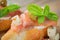 Bruschetta with smoked salmon, cream cheese, olives and arugula