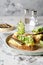 Bruschetta with sprats, egg and cucumber