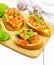 Bruschetta with tomato and spinach on white wooden board