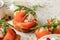 Bruschetta with tomatoes, arugula, olive oil and cheese on white tray on textured background close up. Fresh italian