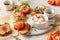 Bruschetta with tomatoes, arugula, olive oil and cheese on white tray on textured background. Fresh italian toasts