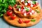 Bruschetta with tomatoes, cheese and greens on toasted bread. Traditional Italian food. Selective focus.