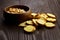 Bruschette chips , baked bread, roasted peanut peeled in a wooden bowl