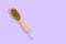 brush for dry skin massage on a pastel violet background,copy space