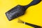 Brush and special tool will help remove tangles and dust stuck between the teeth or bristles. Yellow background. Top view